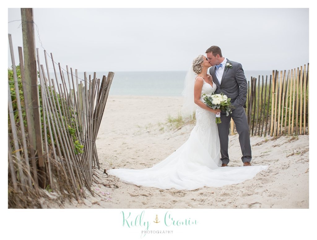 A man kisses his bride after their Bourne Farm Wedding. 