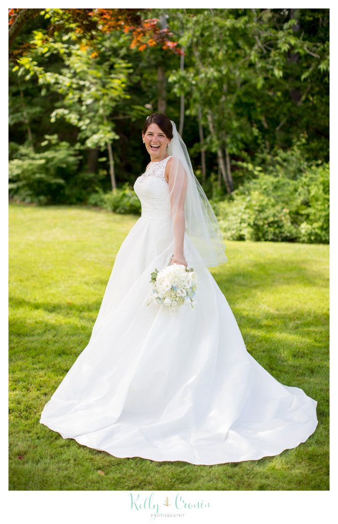 A bride looks over her shoulder in her wedding dress. 