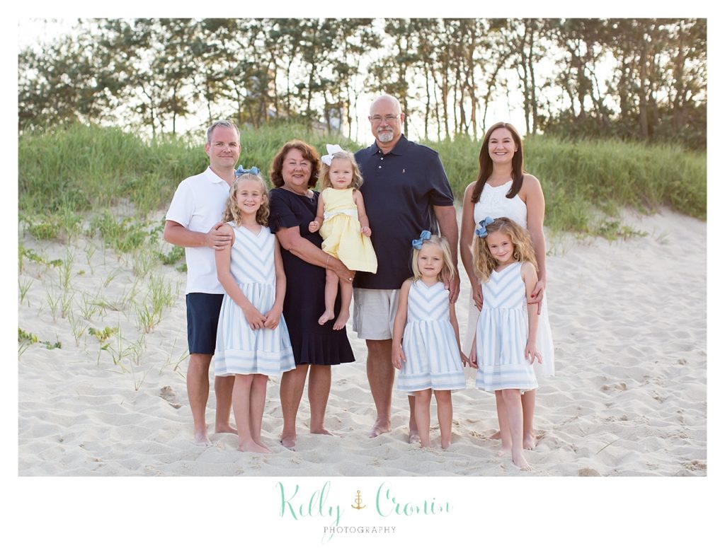 A family poses for their seaside photography session. 