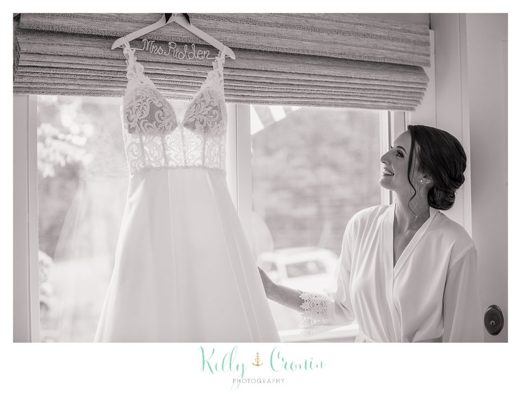 A bride looks at her dress before her Wychmere Beach Club wedding. 