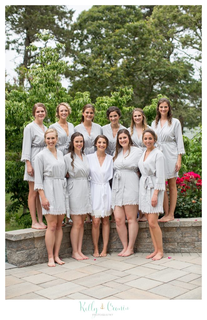 A bridal party poses in their robes before they get ready. 