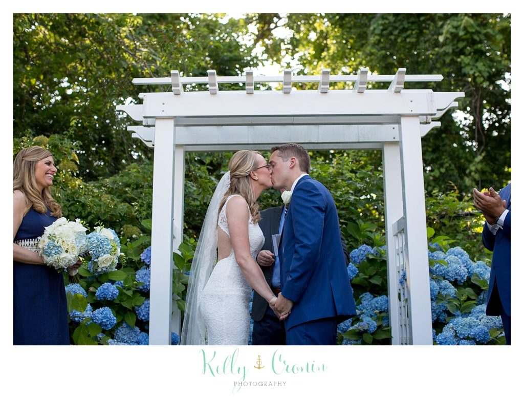A couple share their first kiss after their wedding ceremony. 