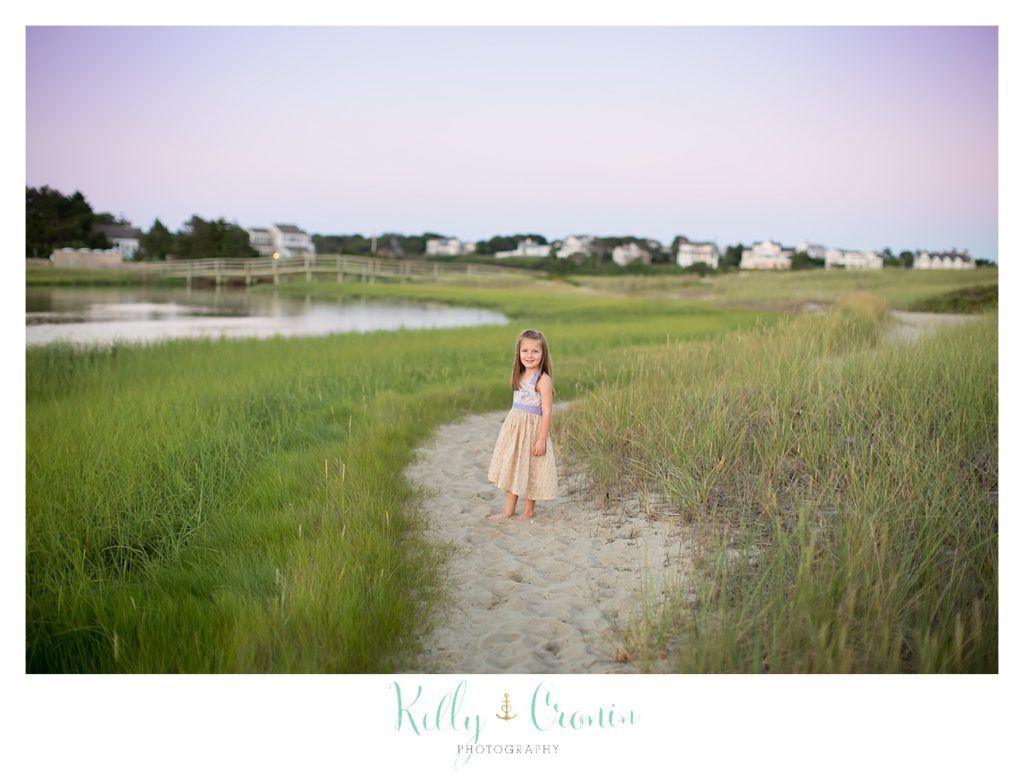 A little girl walks along a path leading to Ridgevale Beach. 
