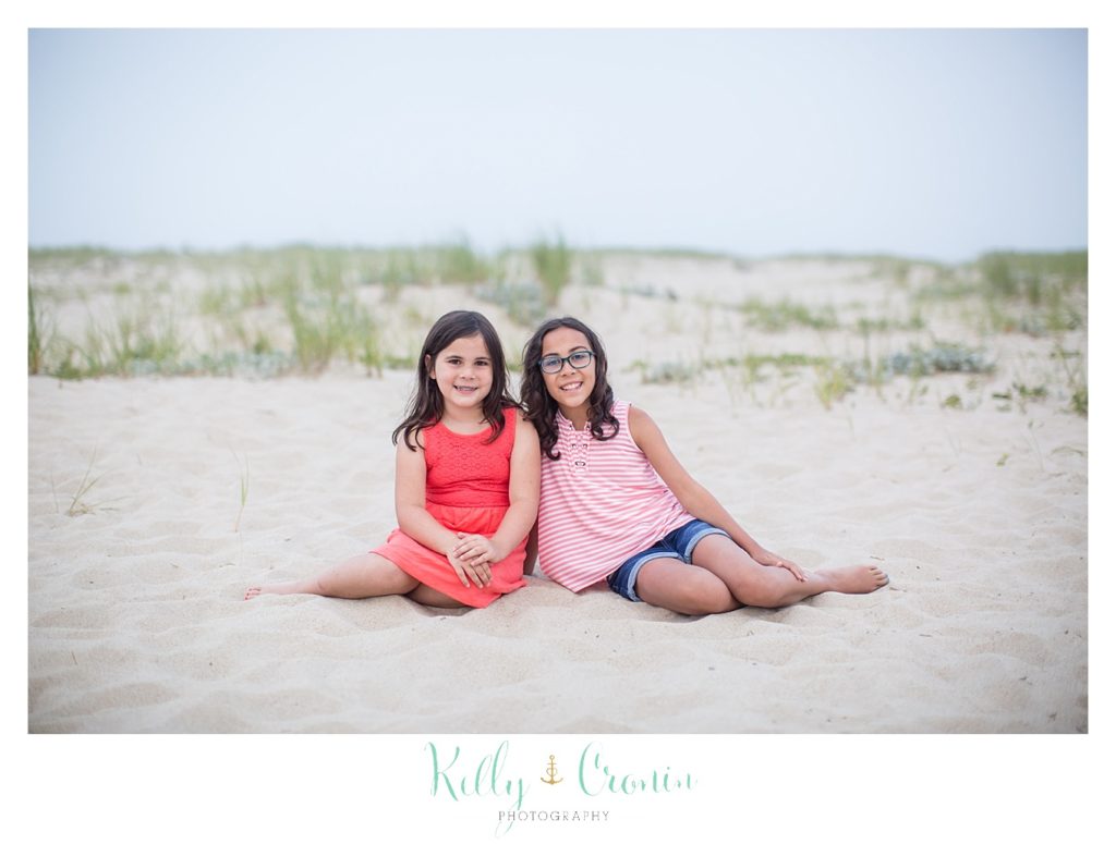 Two sisters sit for a picture during their Family Session. 