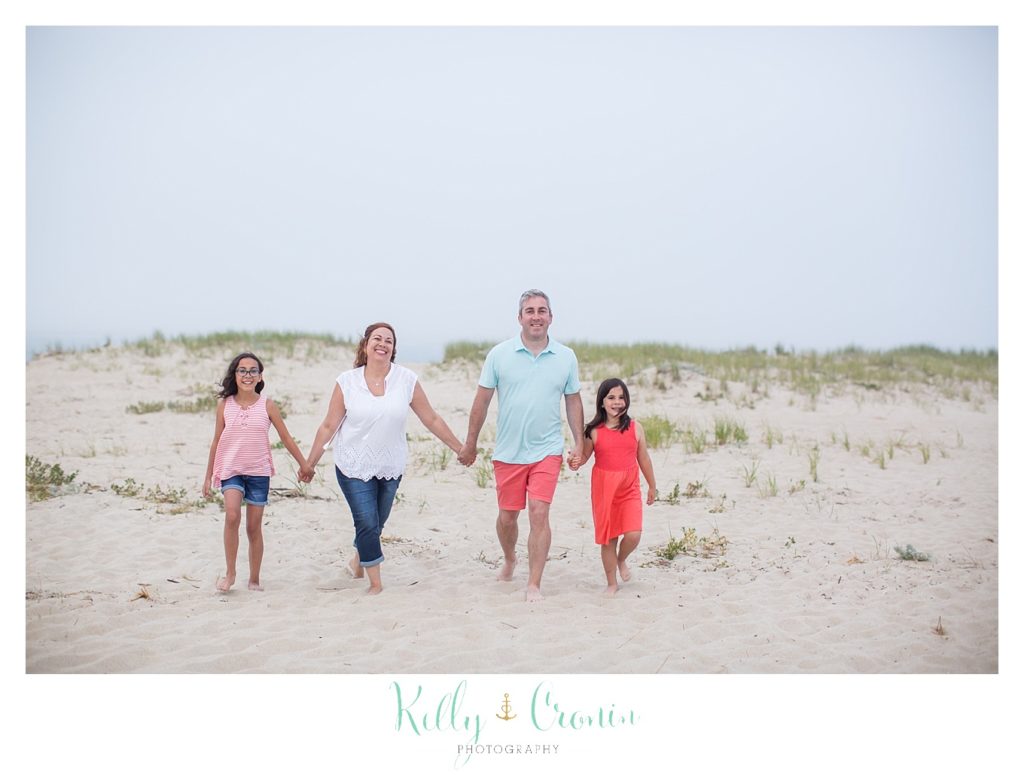 A family holds hands during their Family Session. 