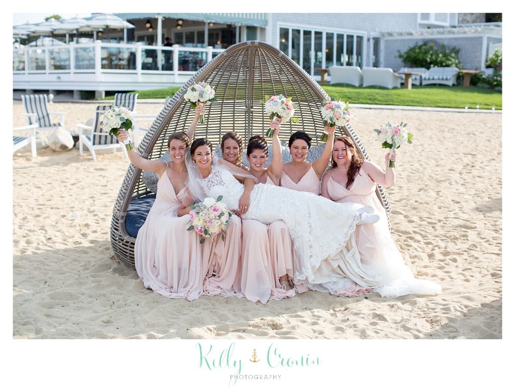 A bridal party sits in a bungalow. 