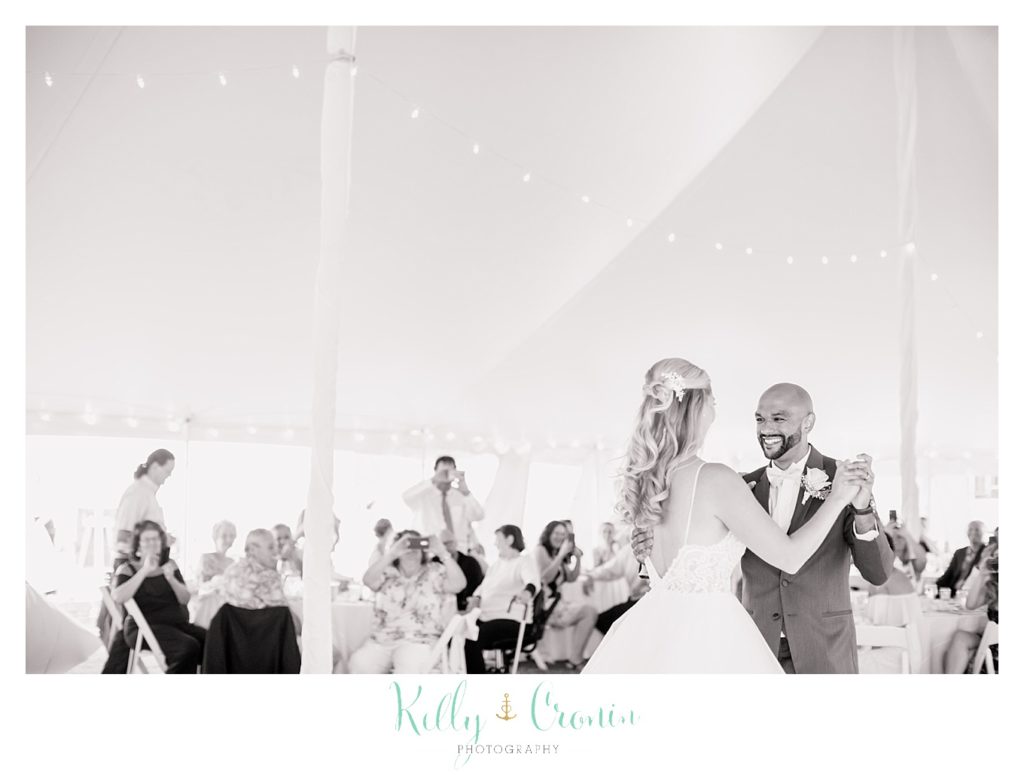 A bride and groom share their first dance together. 
