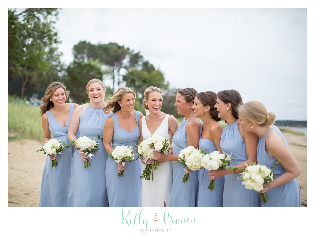 A bridal party laughs together.