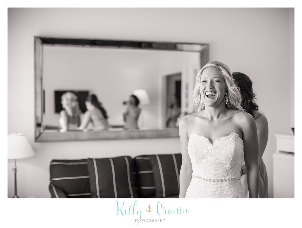 A bride laughs as she gets ready for her Harwich Wedding. 