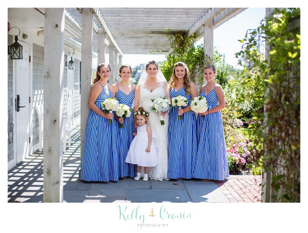 A bride stands with her bridesmaids. 