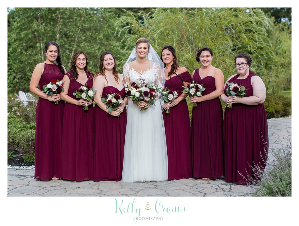 A bride stands with her bridal party. 