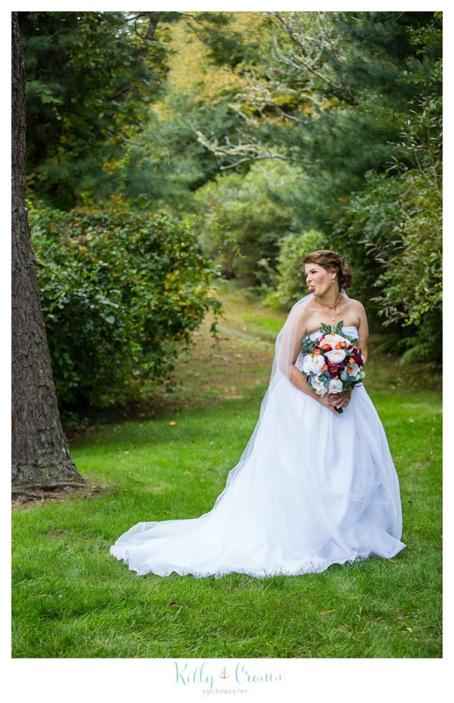 A bride poses for a photograph. 